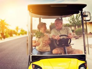 Older couple in golf cart