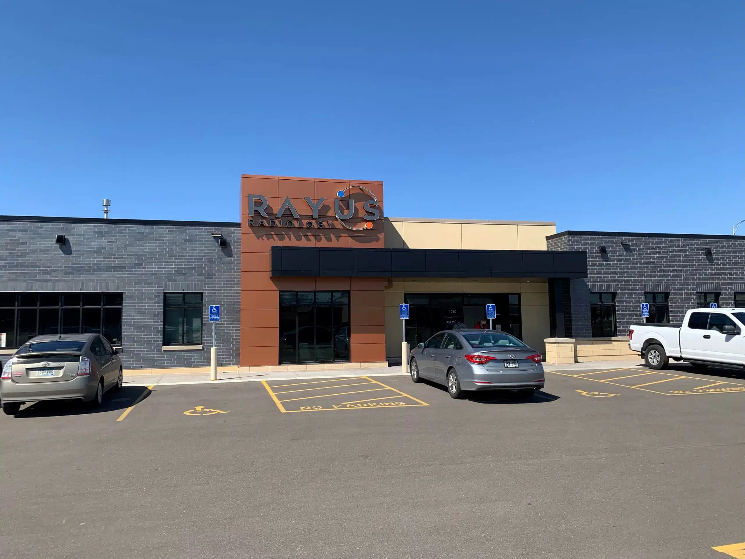 RAYUS Radiology diagnostic imaging center in 1790 Beam Ave., Maplewood, MN 55109 grey and brown building