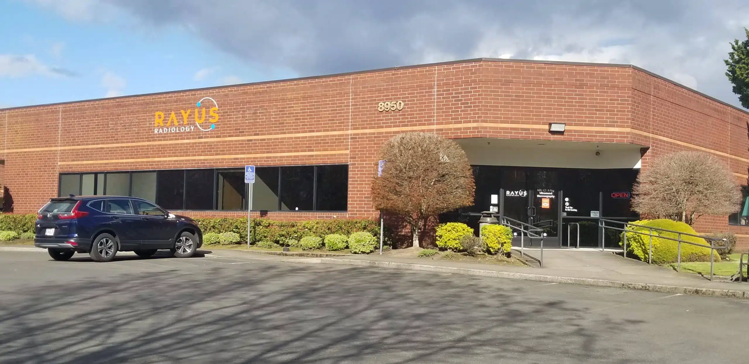 RAYUS Radiology diagnostic imaging center in 8950 SW Nimbus Ave., Beaverton, OR 97008 brick building