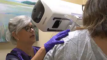 Tech giving patient 3D Mammogram