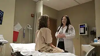 Doctor talking to patient in exam room