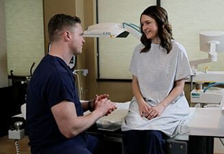 doctor talking to patient in scrubs