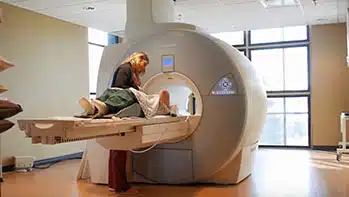 Tech performing MRI on patient