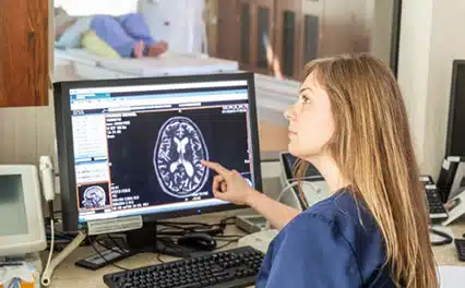 tech at computer pointing to scan