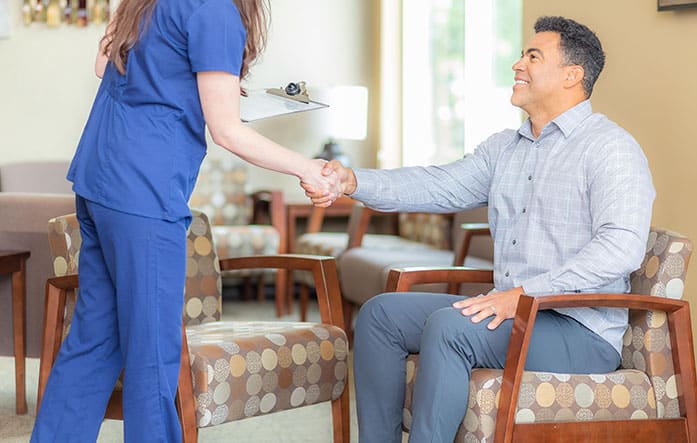 patient shaking hands with technologist