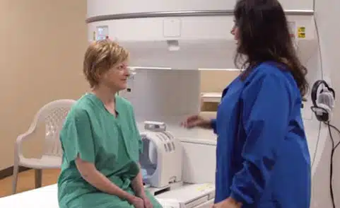 Tech preparing patient for Open MRI