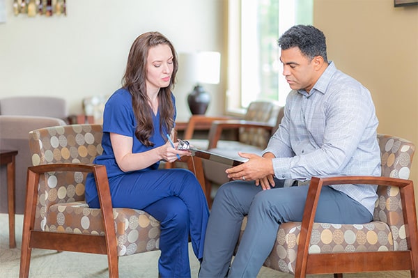 technologist checking patient in