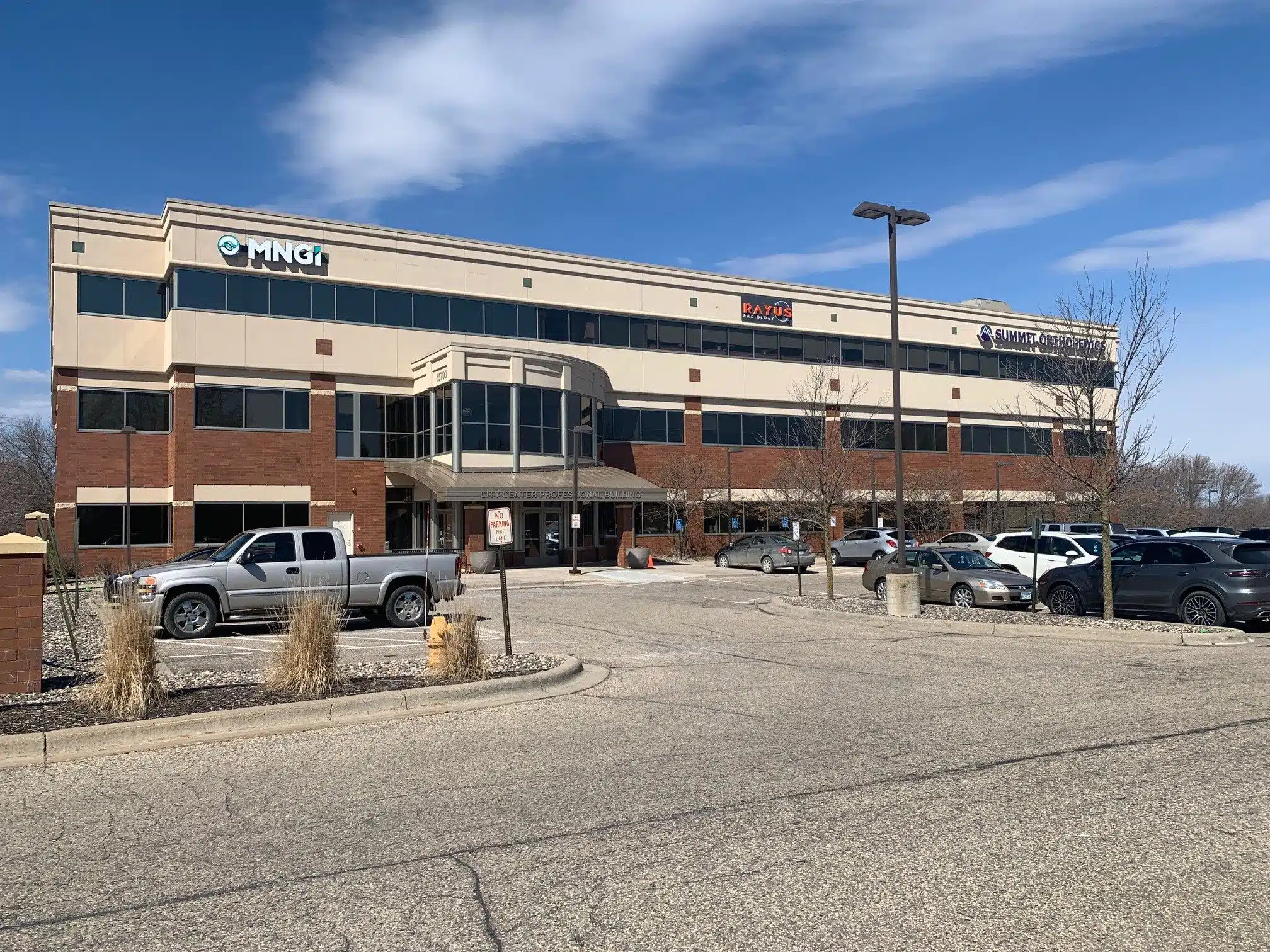 RAYUS Radiology diagnostic imaging center in 15700 37th Ave. N., Suite 100, Plymouth, MN 55446 cream and brown building