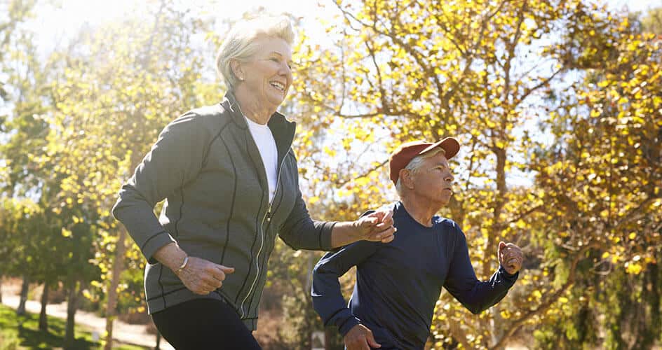 man and woman running while smiling regen