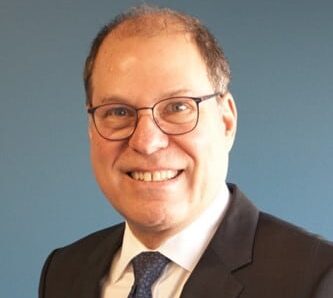 dr. rosenberg man with glasses suit and blue tie