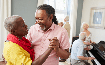 happy couple dancing others playing piano