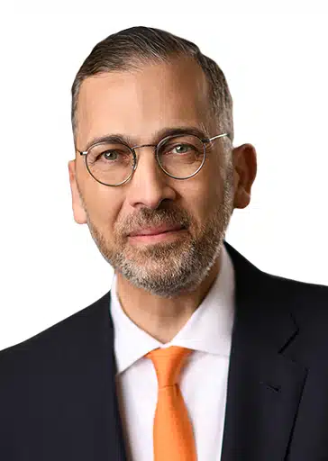 Sami Abbasi RAYUS Radiology CEO man with glasses grey beard black suit jacket and orange tie